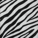  a knotted top and two soft zebra ears on a cream background