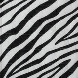  a knotted top and two soft zebra ears on a cream background