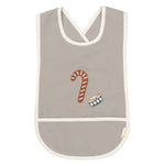 Front of the Fabelab kids organic cotton bib with an embroidered candycane and drum on the front