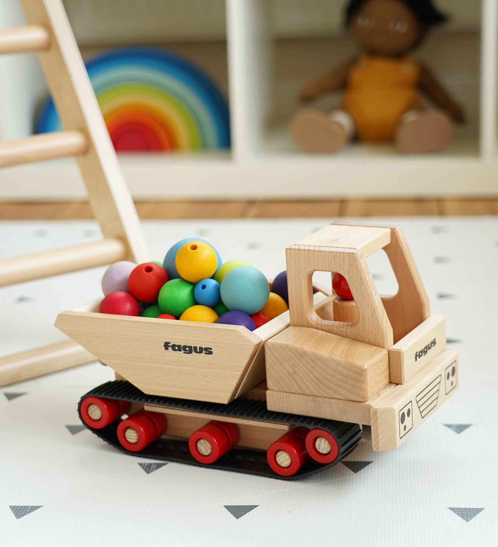 Fagus Wooden Caterpillar Dumper Truck, with the back filled with Grimms wooden beads.