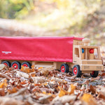 Fagus handmade wooden semi lorry on some brown autumn leaves