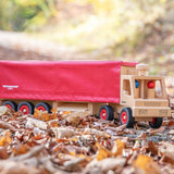 Fagus handmade wooden semi lorry on some brown autumn leaves