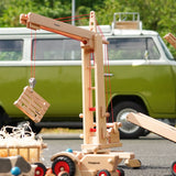 Fagus handmade wooden crane toy with a wooden crate on it's hook.