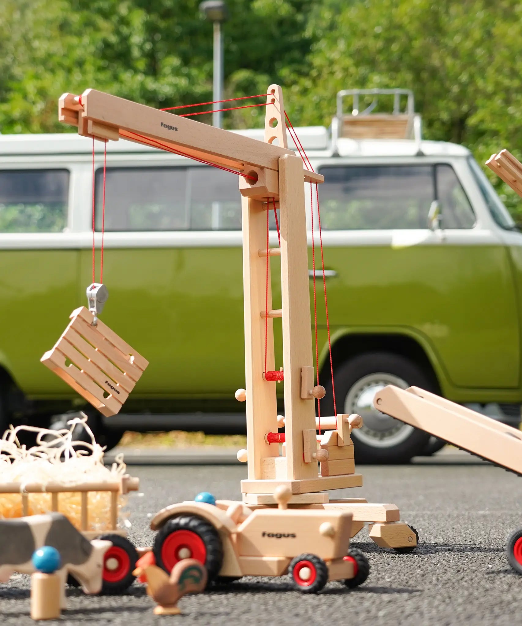 Fagus handmade wooden crane toy with a wooden crate on it's hook.