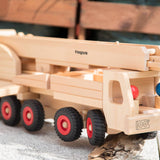 Close up of the Fagus eco-friendly mobile crane toy with its crane down on a grey concrete slab