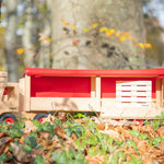 Close up of the Fagus semi truck on some fallen leaves with its trailer open showing off the pallet inside
