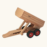 Fagus wooden trailer toy with the trailer bed tipped up.