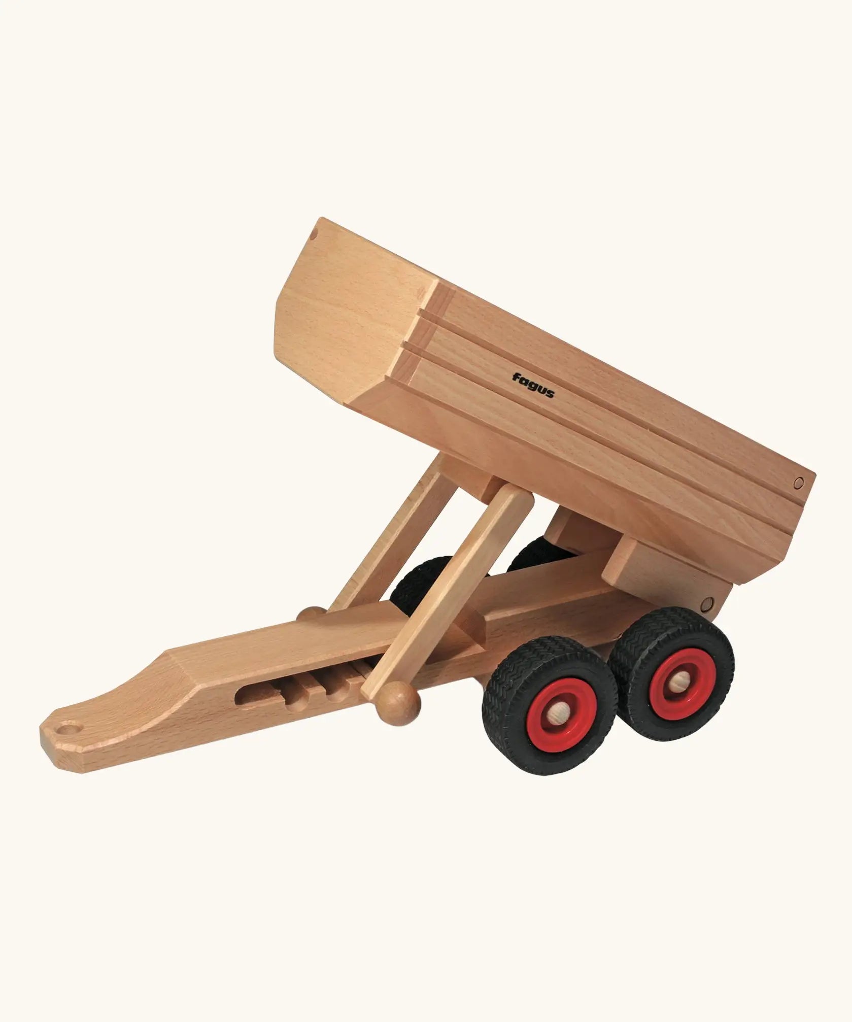Fagus wooden trailer toy with the trailer bed tipped up.