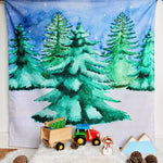 The Wondercloths Christmas Tree Play Cloth in a snowy play scene with the Bajo wooden tractor and Lanka Kade Christmas figures.