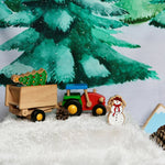 Close up of the Wondercloth Christmas Tree Play Cloth in a snowy play scene with the Bajo wooden tractor and Lanka Kade Christmas figures.