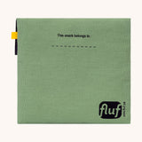 The back of the Fluf Flip Organic Cotton Snack Bag in a moss green colour. A reusable cotton bag with the word 'snack written in black front on the front.