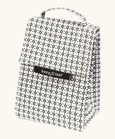 A black and white geometric patterned Fluf lunch bag with a top handle and a black brand label reading 'keep leaf' on the front, shown against a plain off-white background.