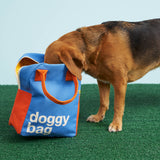 A dog taking a good look inside the Fluf organic cotton zippered doggy bag design lunch bag. The dog has his nose in the bag