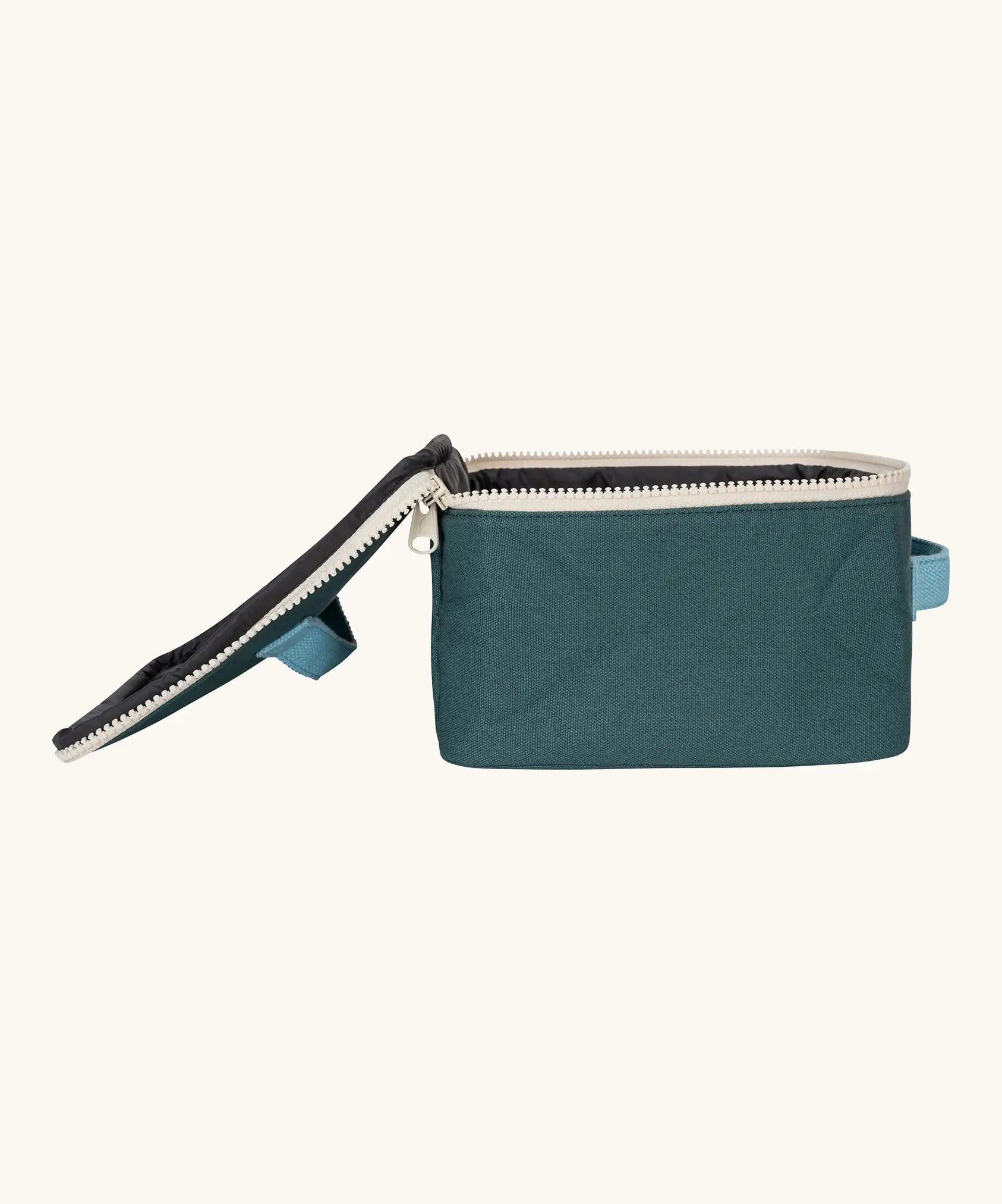 Side view of the Fluf GOTS organic cotton square lunch bag in a cypress with a white zip detail. Features a light blue carry handle on the top and side.