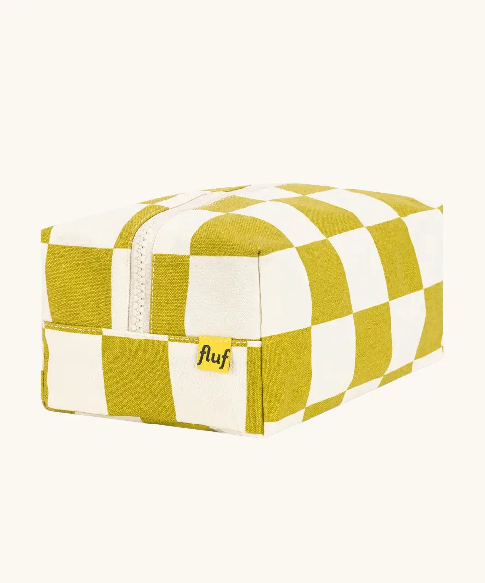 Fluf Traveller Bag in checks pear, a compact organic cotton washbag with lilac carry handle and zip.