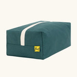 Back of the Fluf Traveller Bag in cypress green, a compact organic cotton washbag with white carry handle and zip.
