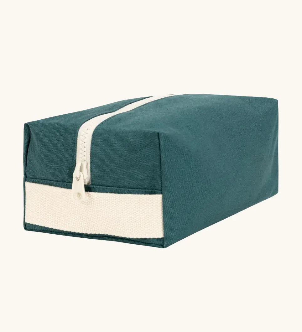 Fluf Traveller Bag in cypress green, a compact organic cotton washbag with white carry handle and zip.
