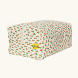 Back of Fluf Traveller Bag in tiny rose print, a compact organic cotton washbag with orange red carry handle and zip.