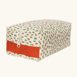 Fluf Traveller Bag in tiny rose print, a compact organic cotton washbag with orange red carry handle and zip.