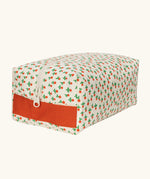 Fluf Traveller Bag in tiny rose print, a compact organic cotton washbag with orange red carry handle and zip.