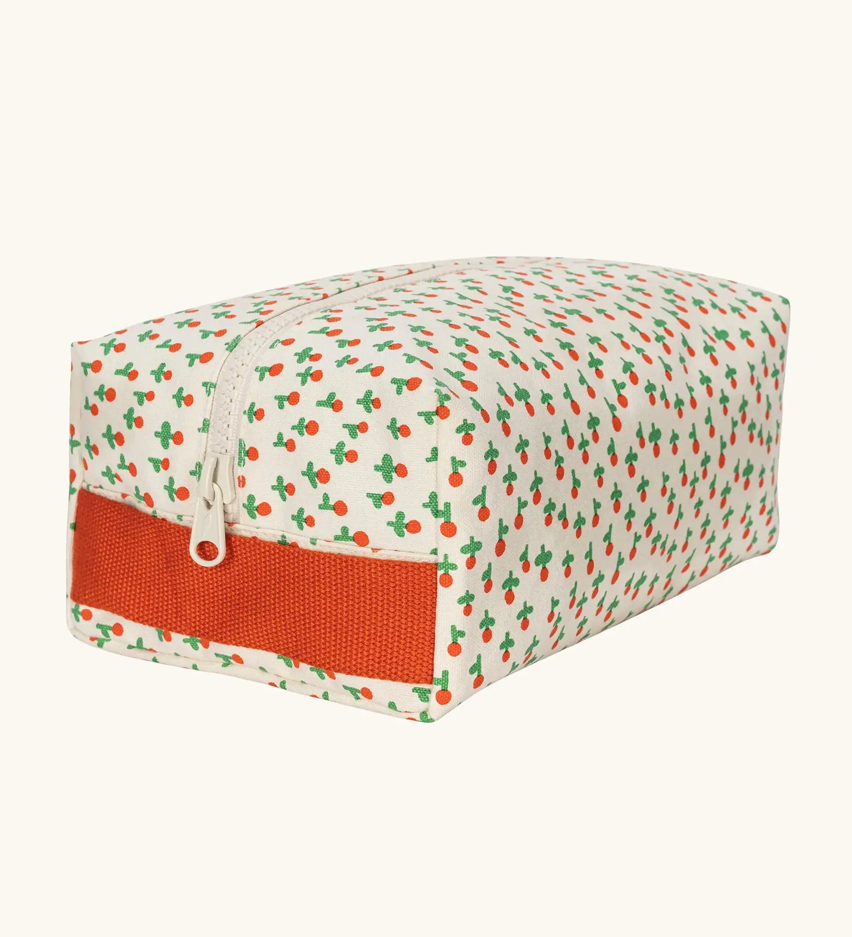 Fluf Traveller Bag in tiny rose print, a compact organic cotton washbag with orange red carry handle and zip.