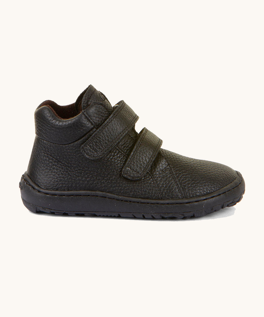 A side image of a Froddo barefoot Autumn children's shoe in black available at Babipur showing the 2 velcro fastener, padded ankle and the matching black sole detail