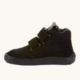 The side of the Froddo Barefoot TEX Kids Autumn Shoes in Black. A soft ankle high shoe in black with a barefoot black rubber sole. Features two velcro straps for a secure fit.  We have a range of children's barefoot shoes available at Babipur. 