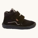 The side of the Froddo Barefoot TEX Kids Autumn Shoes in Black. A soft ankle high shoe in black with a barefoot black rubber sole. Features two velcro straps for a secure fit.  We have a range of children's barefoot shoes available at Babipur. 