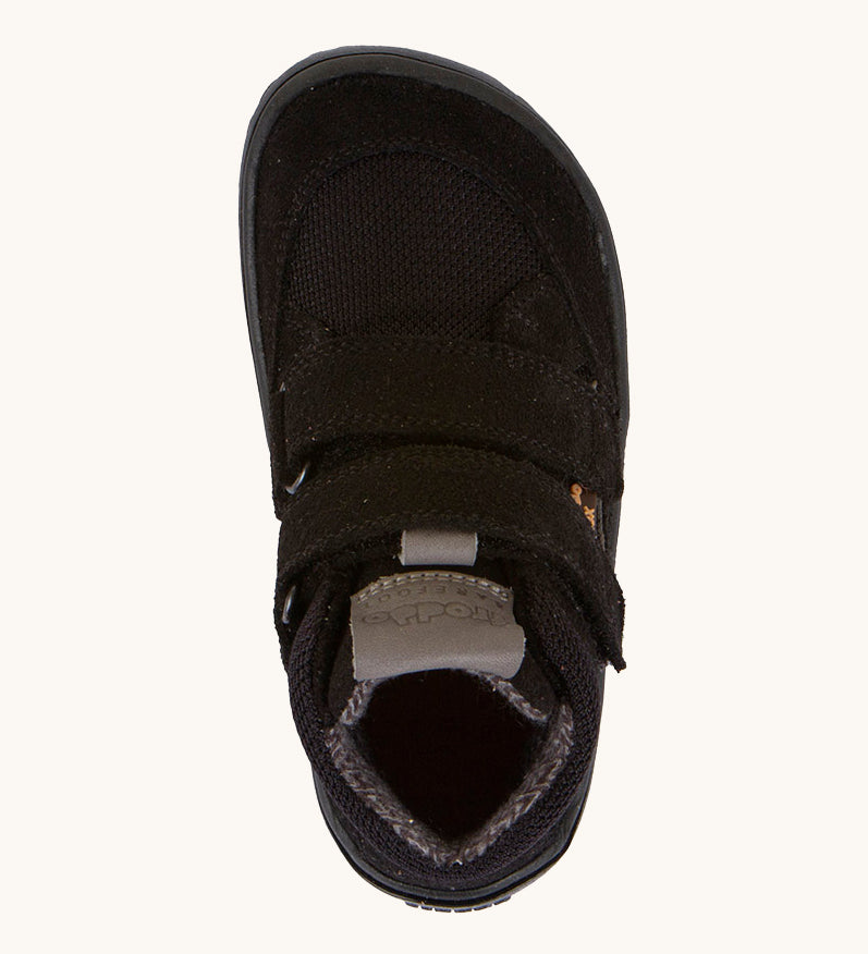 A view from above of the Froddo Barefoot TEX Kids Autumn Shoes in Black showing the wide toe box at the front. A soft ankle high shoe in black with a barefoot black rubber sole. Features two velcro straps for a secure fit.  We have a range of children's barefoot shoes available at Babipur. 