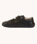 A side view of the Froddo Barefoot Black Alex Kids Leather School Shoes. A black leather child's school shoe with two velcro strap fastenings with a barefoot sole. We have a range of children's barefoot shoes available at Babipur. 