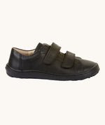 A side view of the Froddo Barefoot Black Alex Kids Leather School Shoes. A black leather child's school shoe with two velcro strap fastenings with a barefoot sole. We have a range of children's barefoot shoes available at Babipur. 