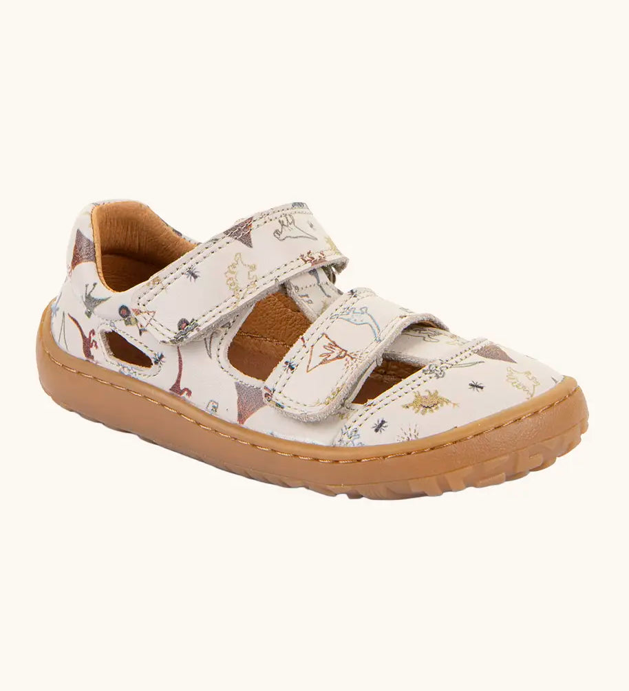 Froddo barefoot kids sandals in beige with a dinosaur themed outline print.