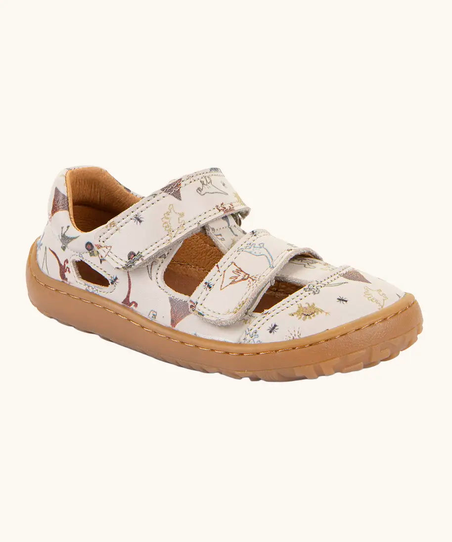Froddo barefoot kids sandals in beige with a dinosaur themed outline print.