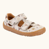 Froddo barefoot kids sandals in beige with a dinosaur themed outline print.