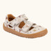 Froddo barefoot kids sandals in beige with a dinosaur themed outline print.