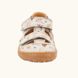 Front of the Froddo barefoot kids sandals in beige with a dinosaur themed outline print.