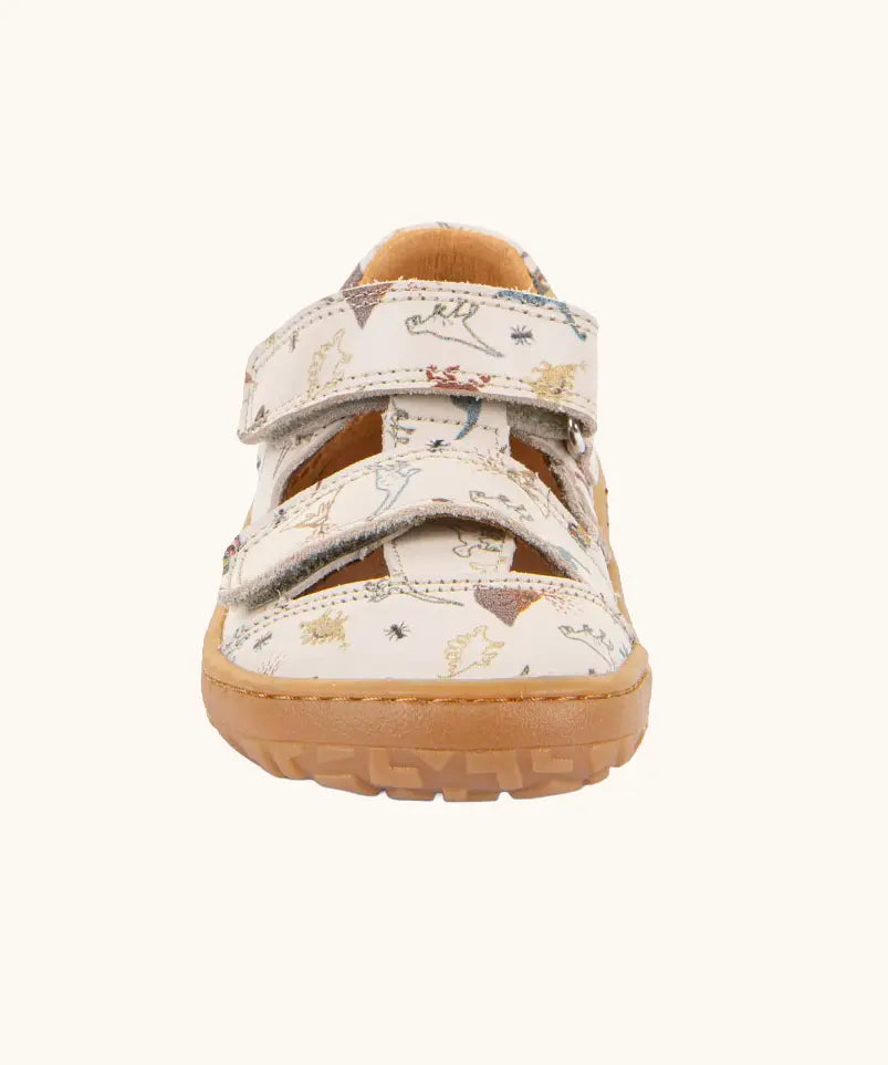 Front of the Froddo barefoot kids sandals in beige with a dinosaur themed outline print.