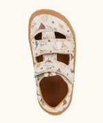 Froddo barefoot kids sandals in beige with a dinosaur themed outline print. Birds eye view.