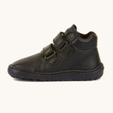 A side image of a Froddo barefoot Autumn children's shoe in black available at Babipur showing the 2 velcro fastener for a secure fit, padded ankle and the matching black grippy sole