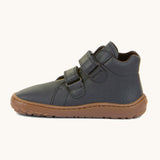 A side image of a Froddo barefoot Autumn children's shoe in dark blue available at Babipur showing the 2 velcro fastener for a secure fit, padded ankle and the dark brown grippy sole