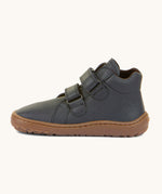 A side image of a Froddo barefoot Autumn children's shoe in dark blue available at Babipur showing the 2 velcro fastener for a secure fit, padded ankle and the dark brown grippy sole