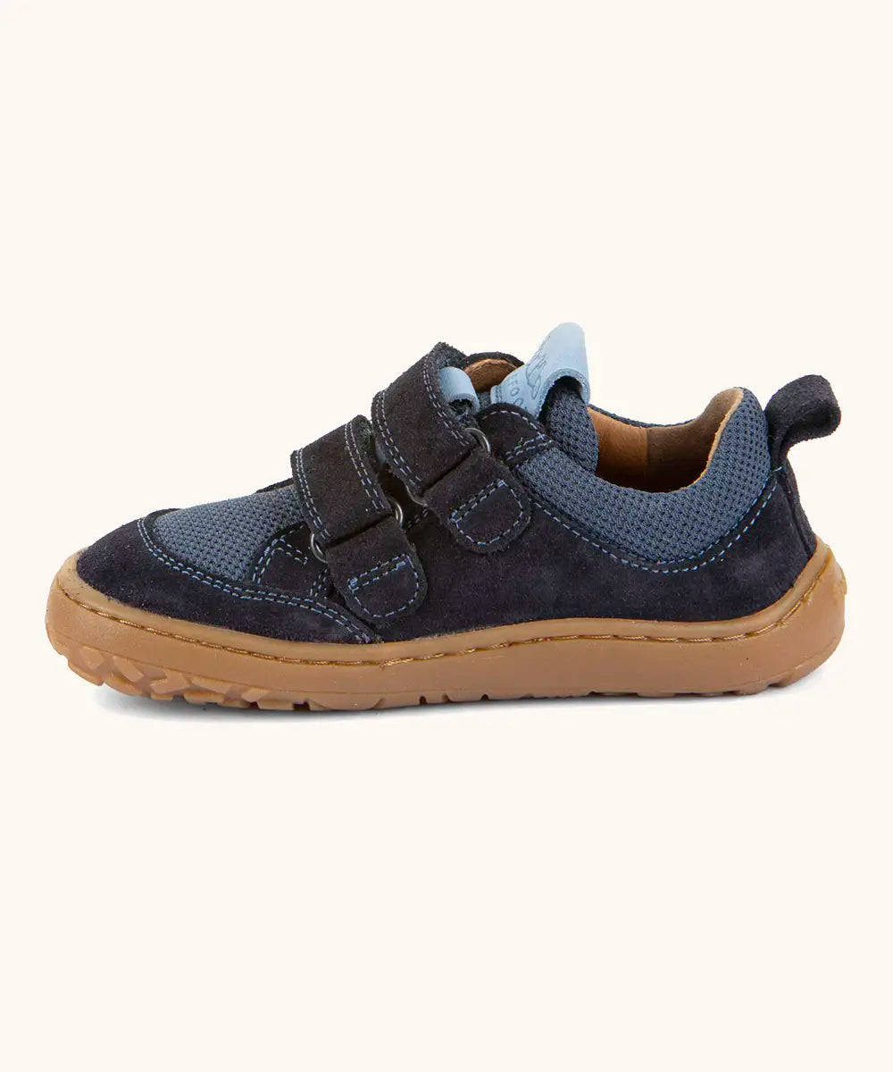 Side of Froddo barefoot base children's shoe in dark blue showing the 2 velcro fasteners looped through the eyelets