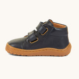 A side image of the Froddo barefoot first step baby shoe in dark blue available at Babipur showing the 2 velcro fastener for a secure fit and the grippy sole detail