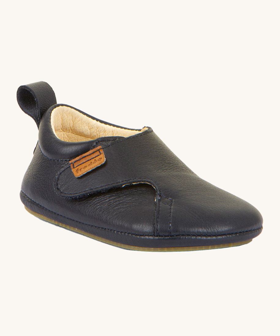 Froddo barefoot walker baby shoe in dark blue. A natural leather shoe with a pull tab on the back for easy fitting, a velcro fastener and a grippy sole