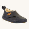 Froddo barefoot walker baby shoe in dark blue. A natural leather shoe with a pull tab on the back for easy fitting, a velcro fastener and a grippy sole