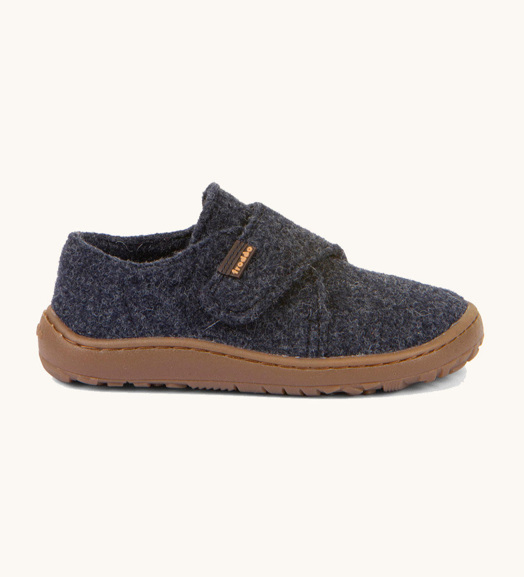 A side image of the Froddo barefoot wooly children's shoe in dark blue available at Babipur showing the velcro fastener dark brown grippy sole detail
