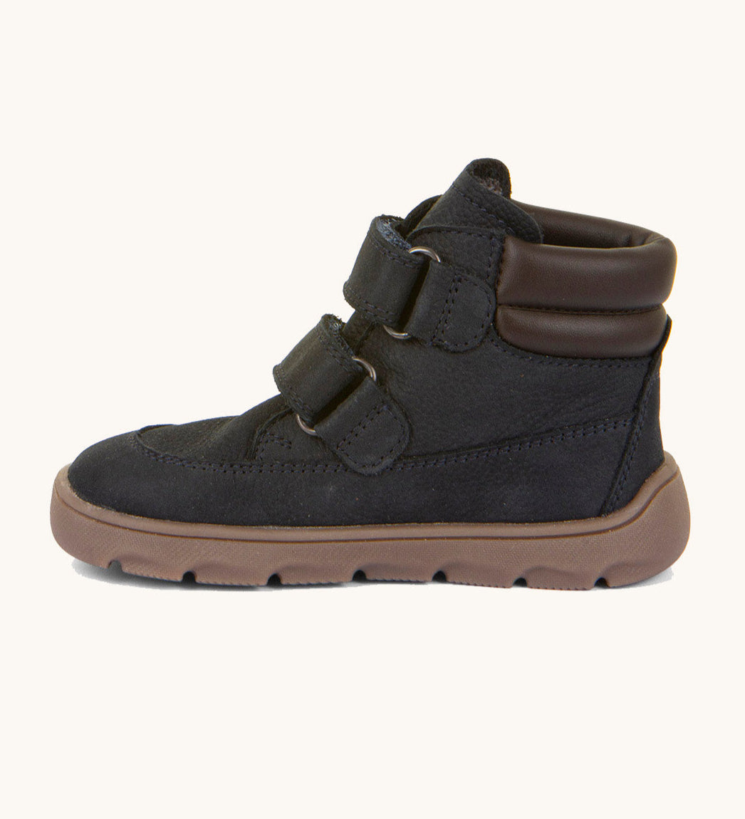 A side image of the Froddo barefoot Zuru tex children's shoe in dark blue available at Babipur showing the 2 velcro fasteners, padded ankle support and the dark brown grippy sole detail