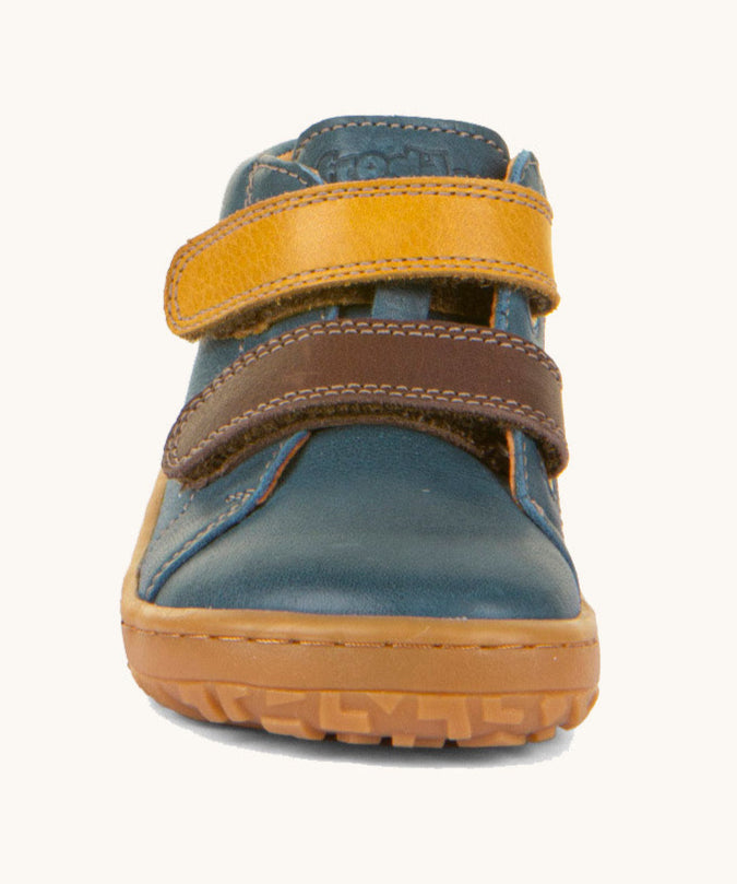 The front of the Froddo barefoot first step baby shoe in dark denim available at Babipur showing the 2 velcro fastener in dark yellow and brown for a secure fit. 