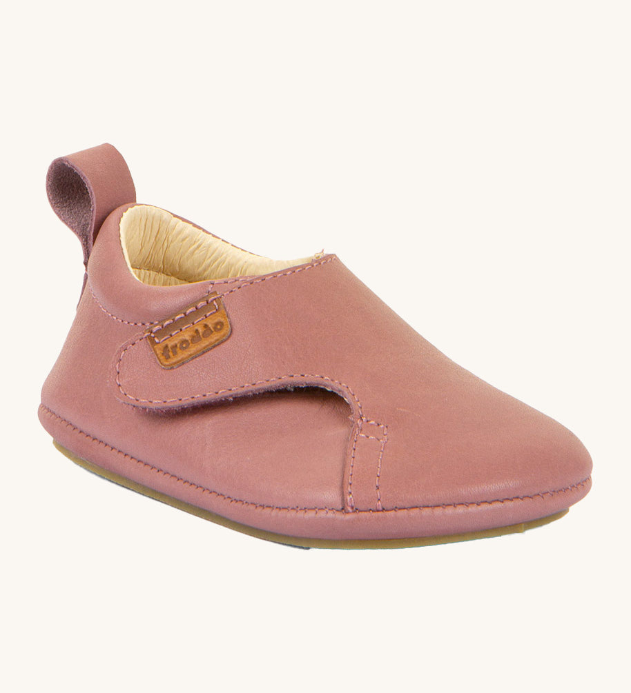 Froddo barefoot walker baby shoe in dark pink. A natural leather shoe with a pull tab on the back for easy fitting, a velcro fastener and a grippy sole