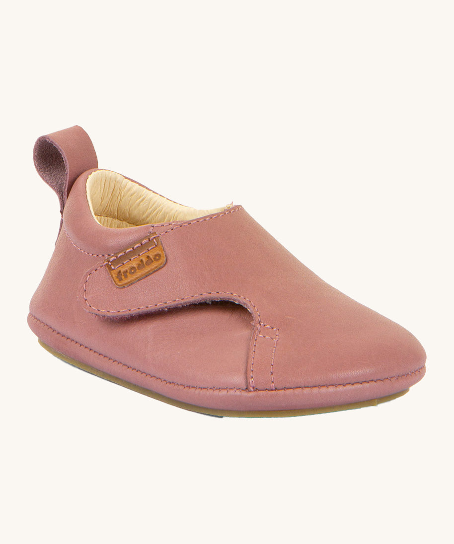 Froddo barefoot walker baby shoe in dark pink. A natural leather shoe with a pull tab on the back for easy fitting, a velcro fastener and a grippy sole